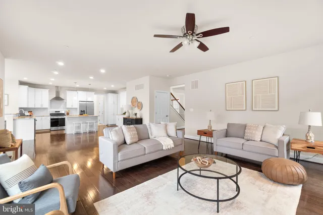 a living room with furniture and kitchen view