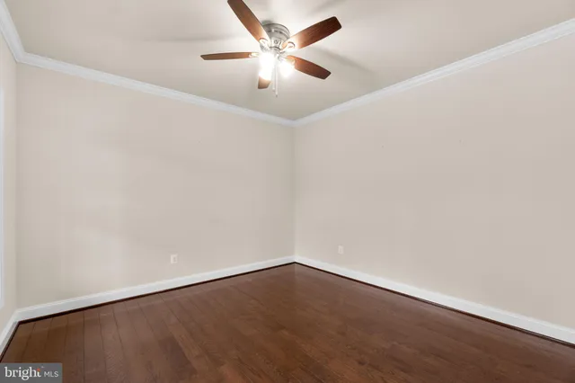 an empty room with a fan and a ceiling fan