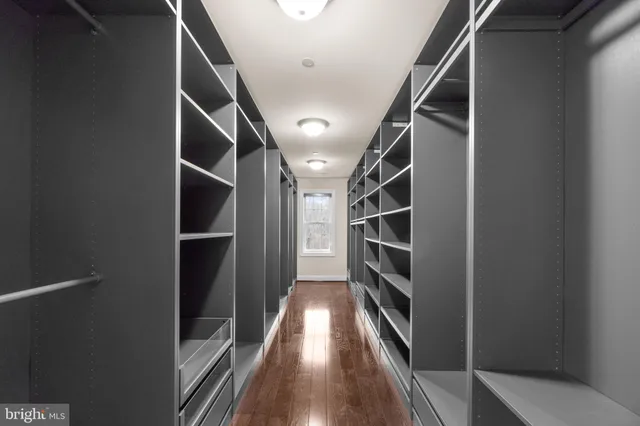 a view of hallway with stairs and wooden floor