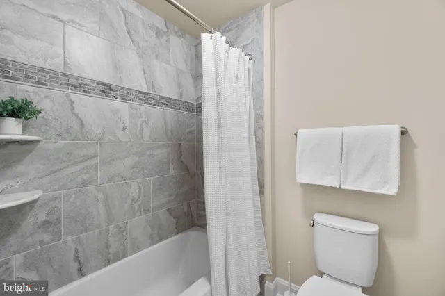 a bathroom with a shower and a toilet
