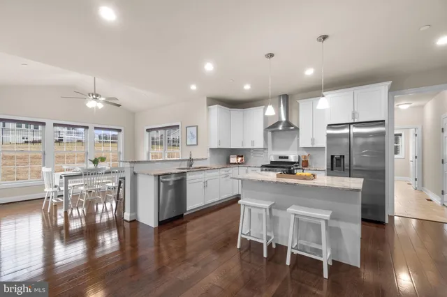 a kitchen with a table chairs refrigerator and cabinets