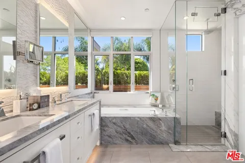 a spacious bathroom with a granite countertop sink and a large mirror
