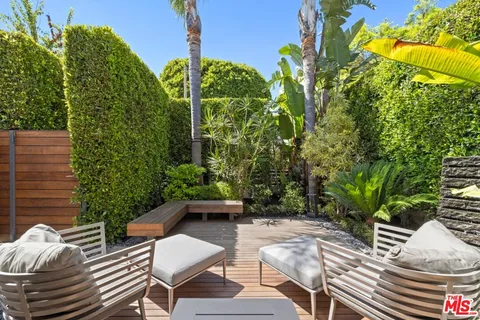a view of backyard with outdoor seating and green space