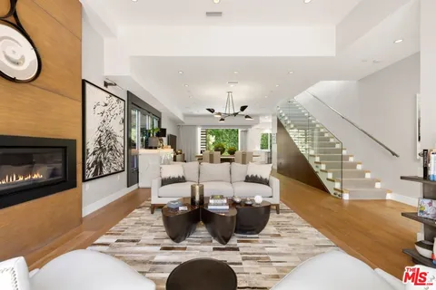 a living room with fireplace furniture and a fireplace