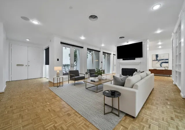 a living room with furniture a fireplace and a flat screen tv