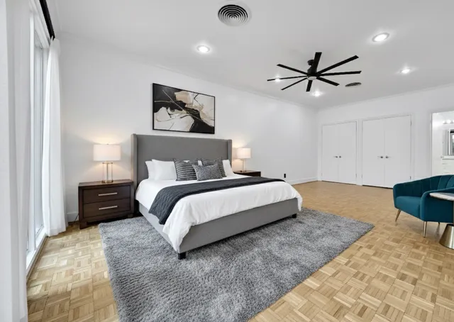 a bedroom with a bed and painting on the wall