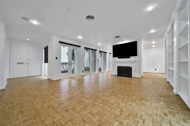 a view of a livingroom with a flat screen tv fire place and a fireplace