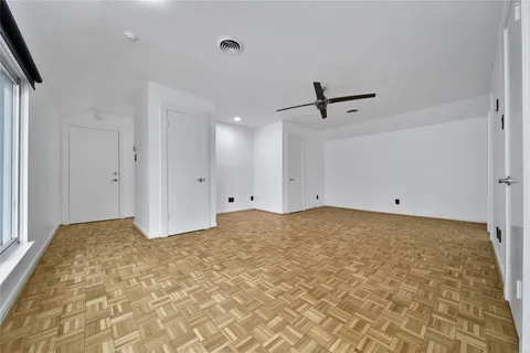 a view of a livingroom with a ceiling fan and window