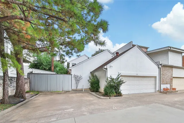 a view of backyard with small cabin and wooden fence