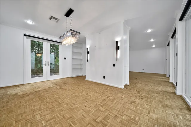 a view of a big room with windows and chandelier