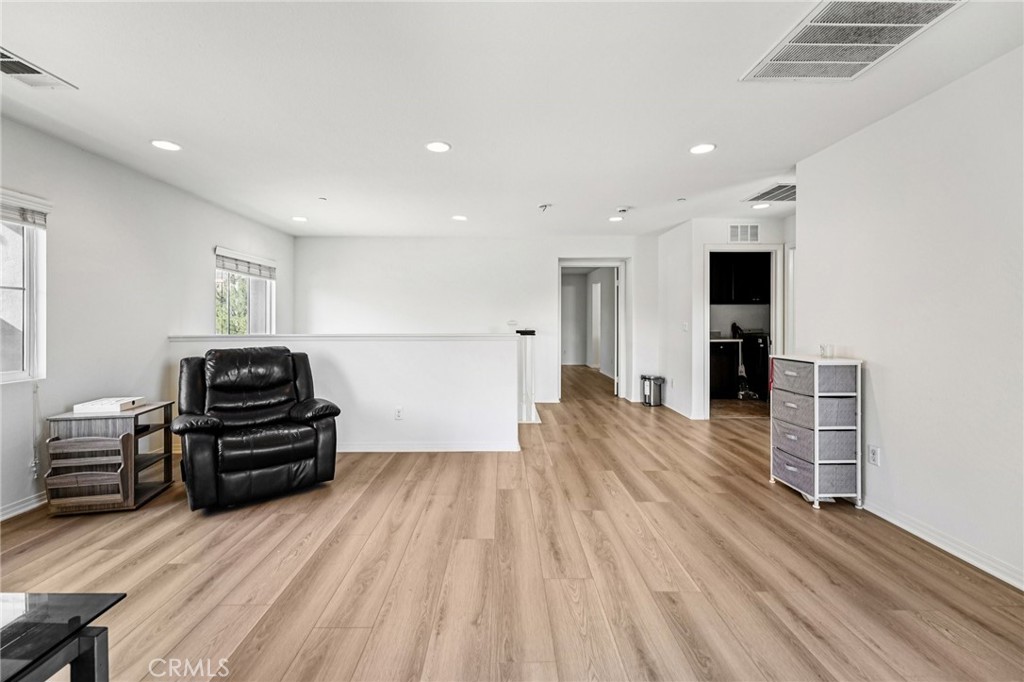 12936 Canopy Court Rancho Cucamonga, CA 91739 - Photo 12 of 32 a view of a living room with furniture and wooden floor