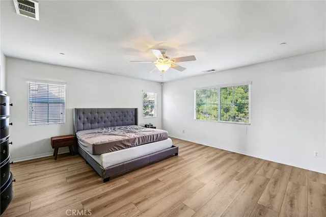 a spacious bedroom with a bed and a window