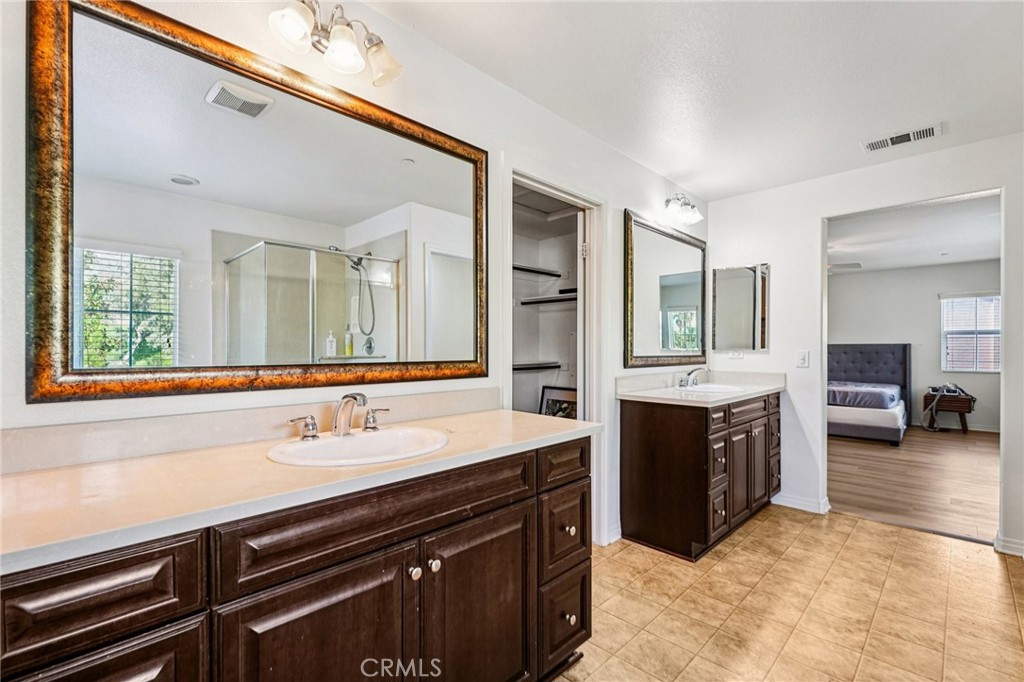 12936 Canopy Court Rancho Cucamonga, CA 91739 - Photo 17 of 32 a spacious bathroom with a sink double vanity and a mirror