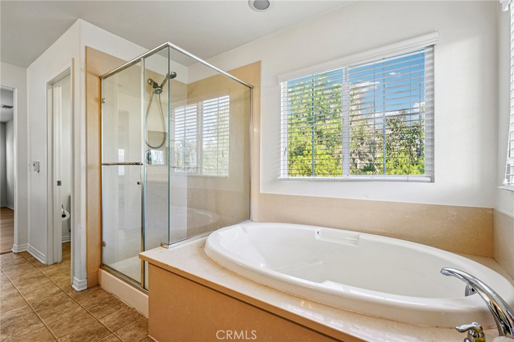 12936 Canopy Court Rancho Cucamonga, CA 91739 - Photo 19 of 32 a bathroom with a bathtub and a shower
