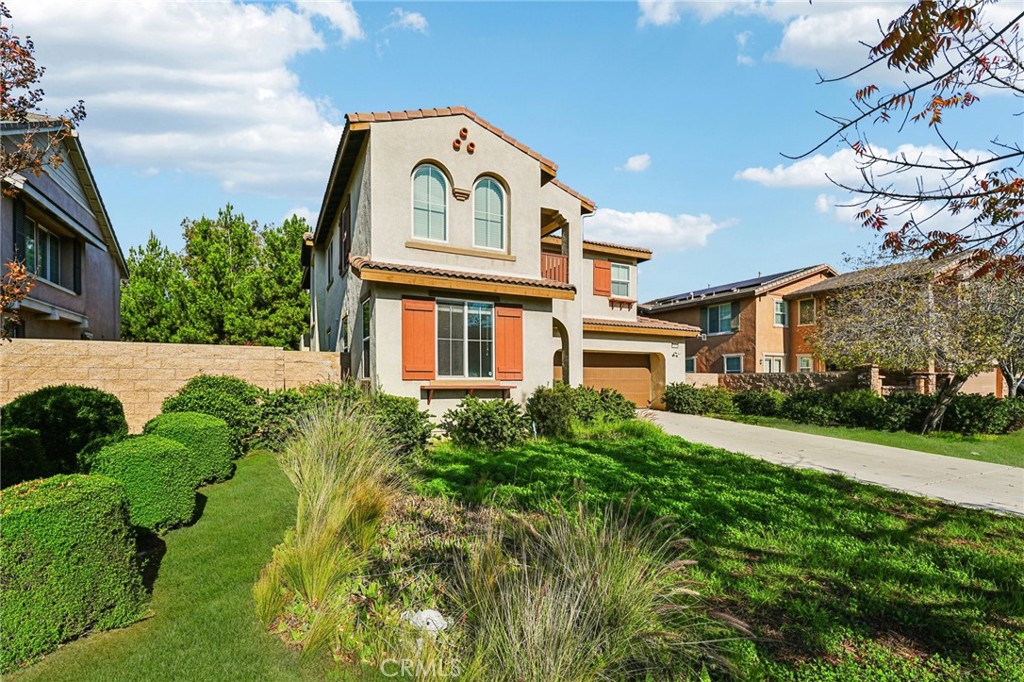 12936 Canopy Court Rancho Cucamonga, CA 91739 - Photo 2 of 32 a view of a white house with a big yard and potted plants