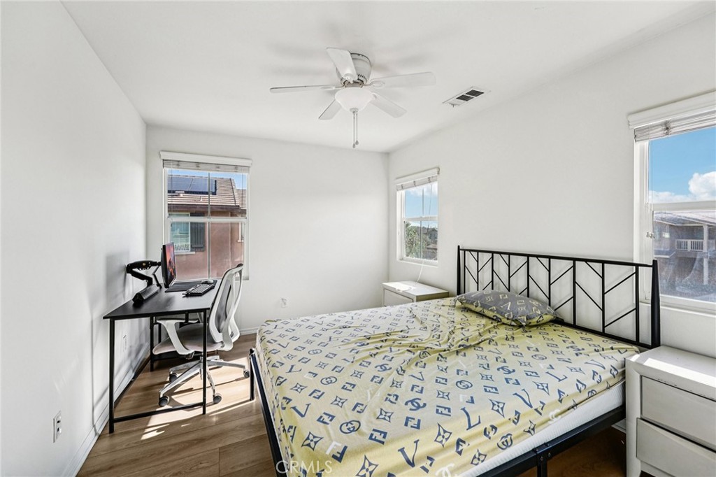12936 Canopy Court Rancho Cucamonga, CA 91739 - Photo 21 of 32 a bedroom with a bed and a table in it