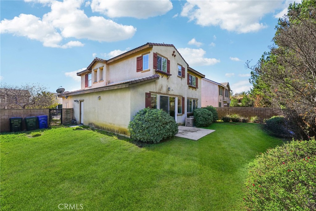 12936 Canopy Court Rancho Cucamonga, CA 91739 - Photo 27 of 32 a front view of a house with garden