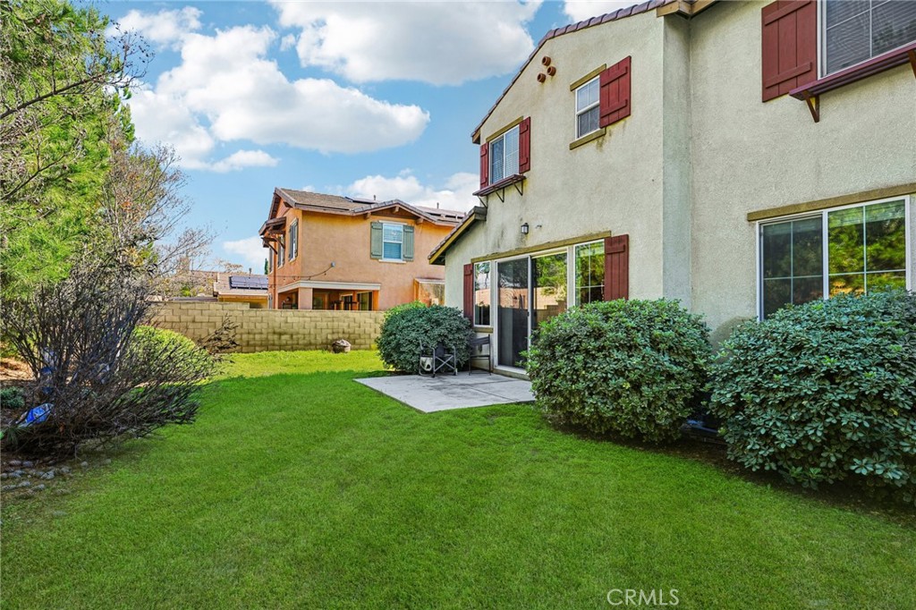 12936 Canopy Court Rancho Cucamonga, CA 91739 - Photo 28 of 32 a front view of a house with garden