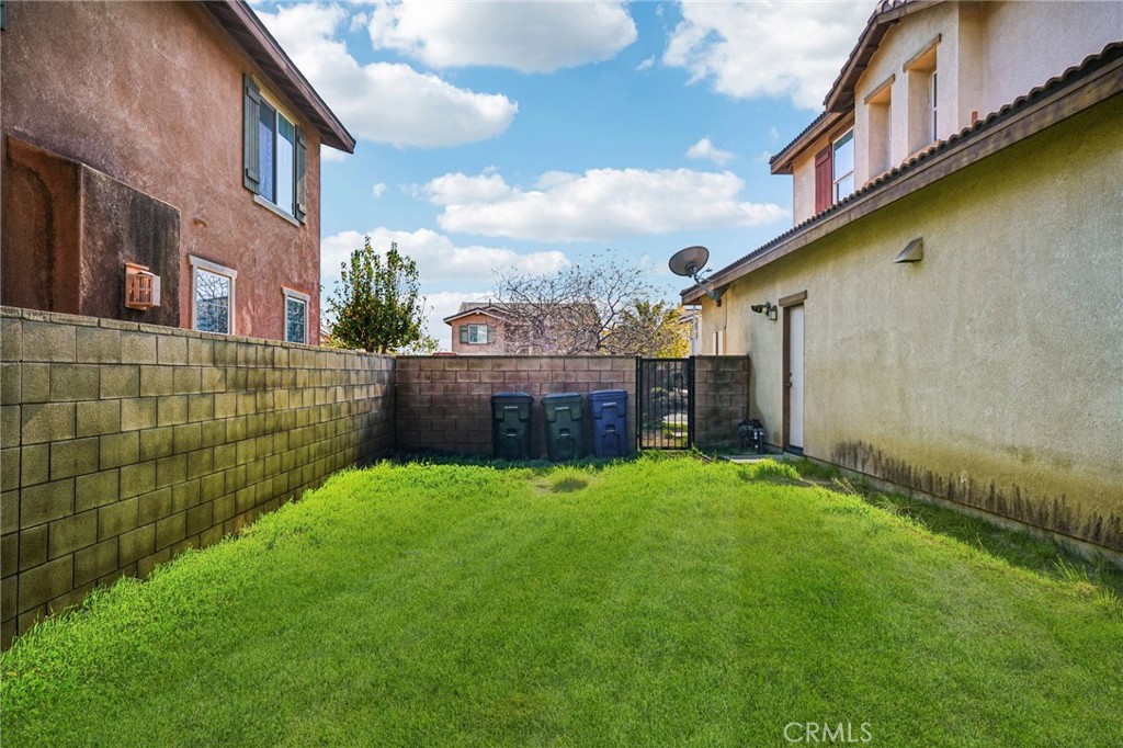 12936 Canopy Court Rancho Cucamonga, CA 91739 - Photo 29 of 32 a view of backyard with barbeque grill and wooden fence