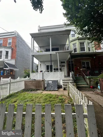 a view of house with a yard