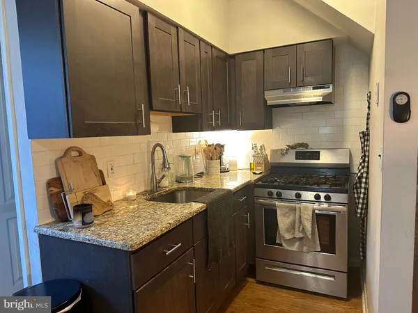 a kitchen with a stove and a sink