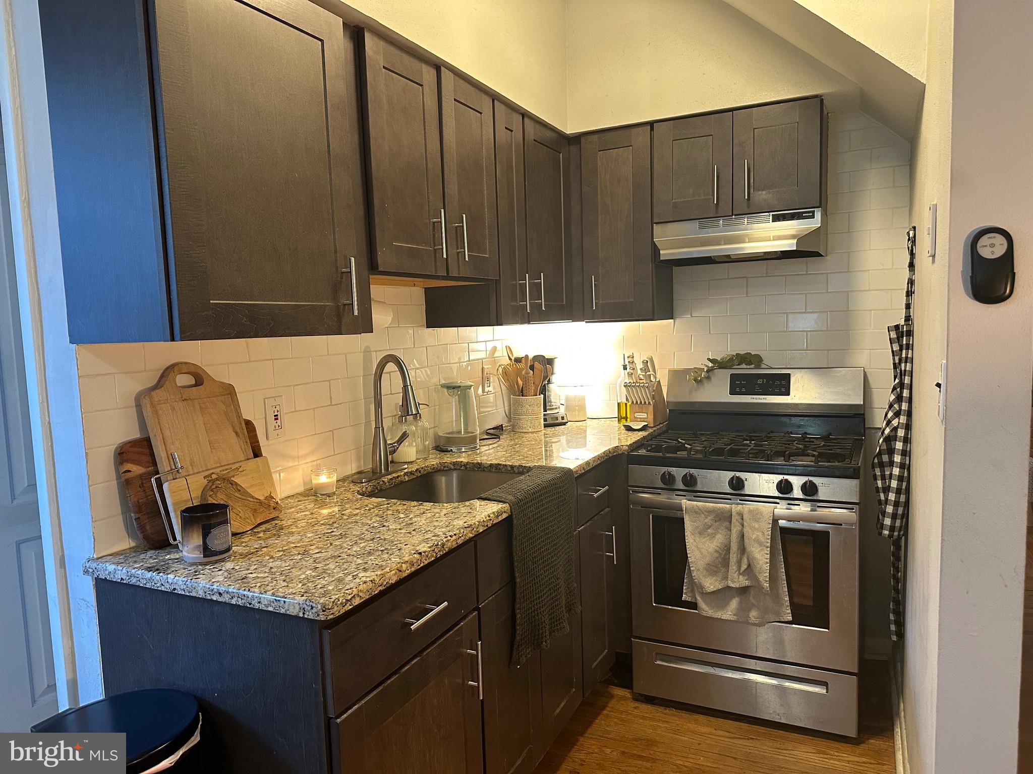 275 Rochelle Avenue, Unit 2 Philadelphia, PA 19128 - Photo 5 of 18 a kitchen with a stove and a sink