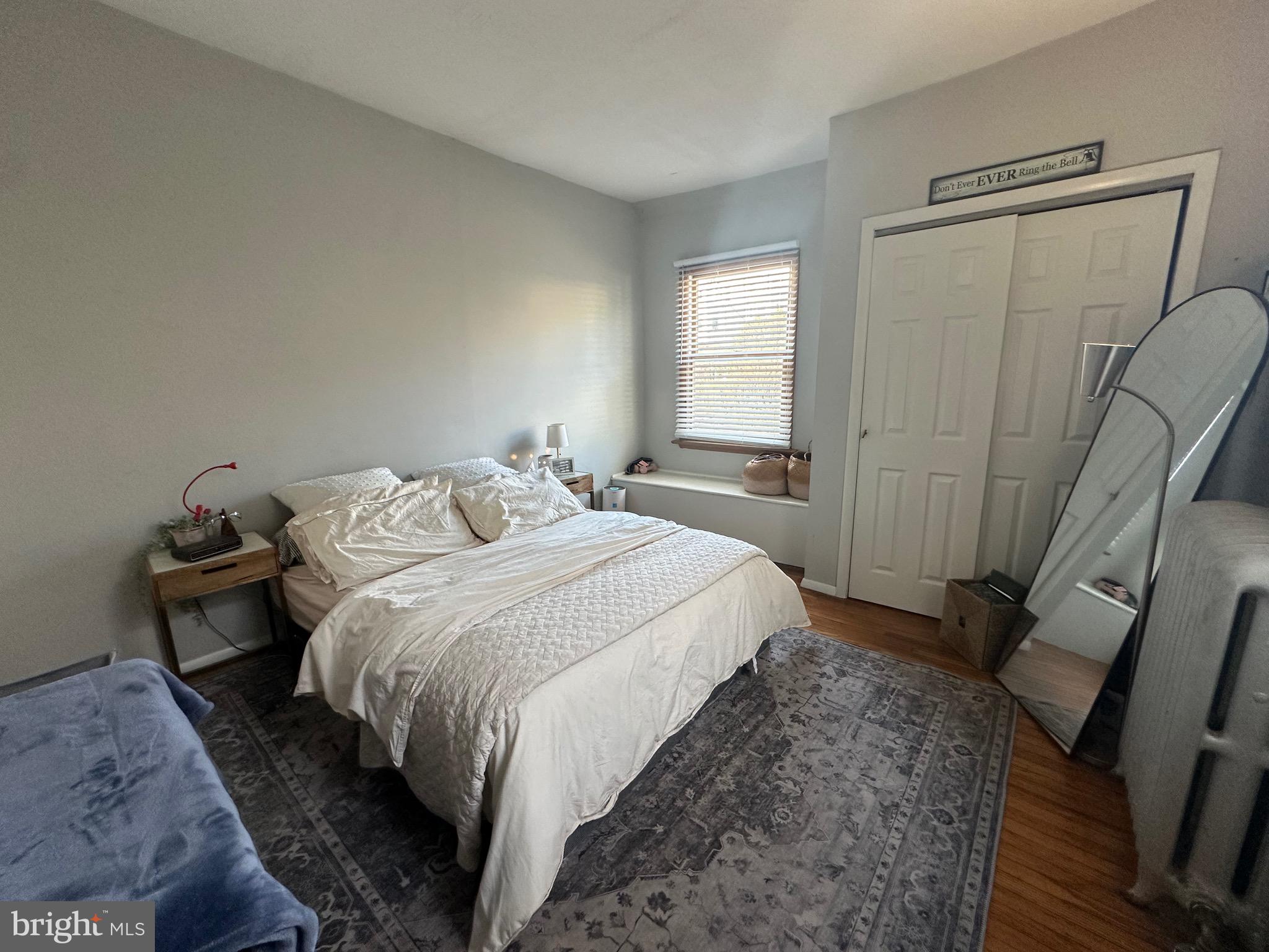 275 Rochelle Avenue, Unit 2 Philadelphia, PA 19128 - Photo 10 of 18 a bedroom with a bed and wooden floor