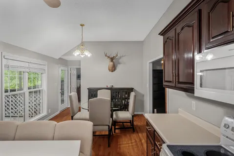a living room with furniture a window and wooden floor