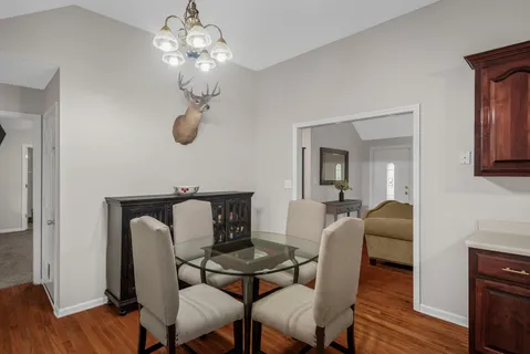 a dining room with furniture and wooden floor