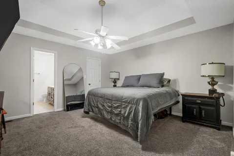 a spacious bedroom with a bed and a chandelier