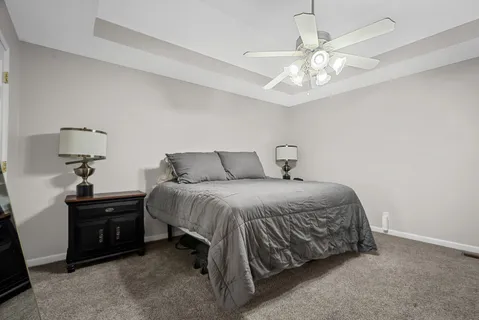 a bedroom with a bed and a chandelier