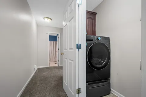 a view of a hallway with washer and dryer