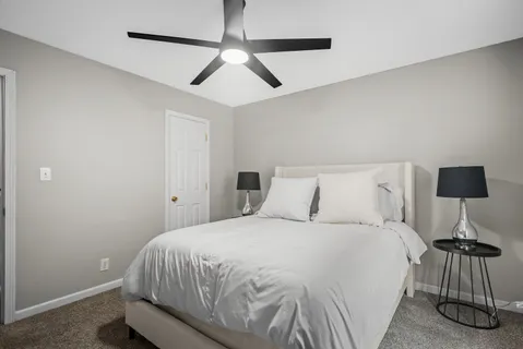 a bedroom with a bed and a lamp on table