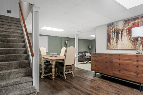 a view of a dining room with furniture and wooden floor