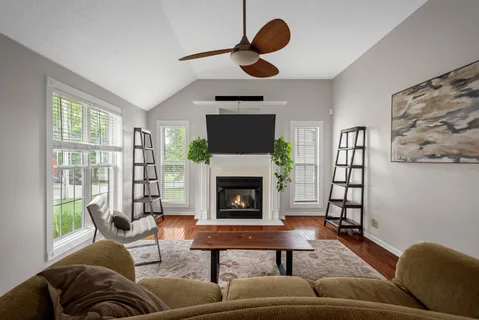 a living room with furniture and a fireplace