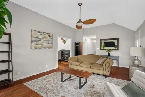 a living room with furniture and a wooden floor