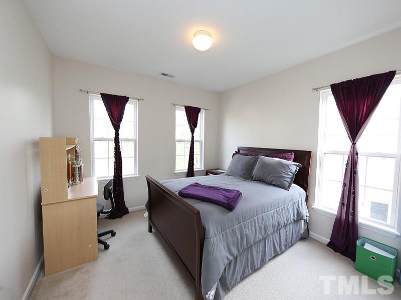 2304 Spruce Shadows Lane Raleigh, NC 27614 - Photo 15 of 25 a bedroom with a bed and a large window