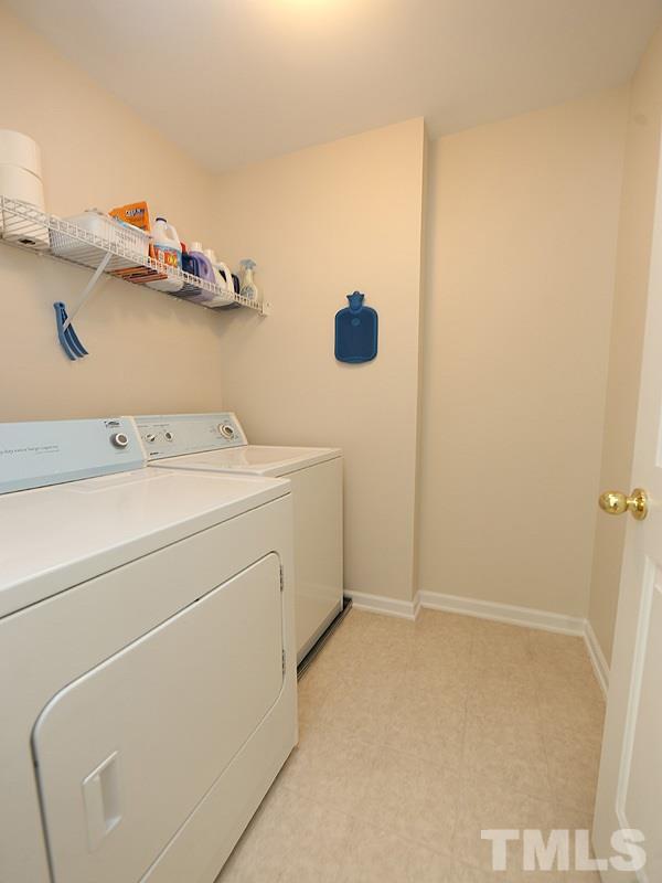 2304 Spruce Shadows Lane Raleigh, NC 27614 - Photo 18 of 25 a utility room with dryer and washer