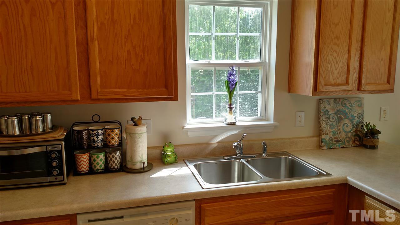 2304 Spruce Shadows Lane Raleigh, NC 27614 - Photo 4 of 25 a kitchen with a sink and a window