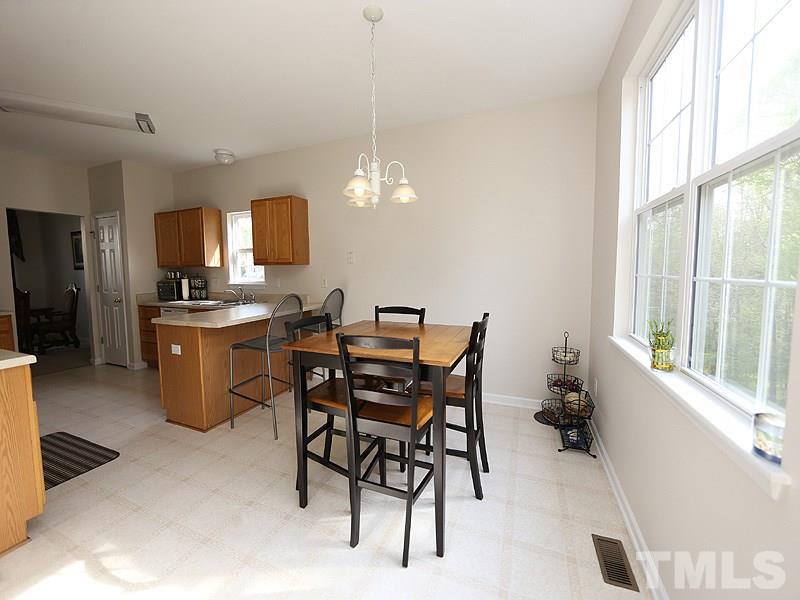 2304 Spruce Shadows Lane Raleigh, NC 27614 - Photo 7 of 25 a view of a dining room with furniture and a window