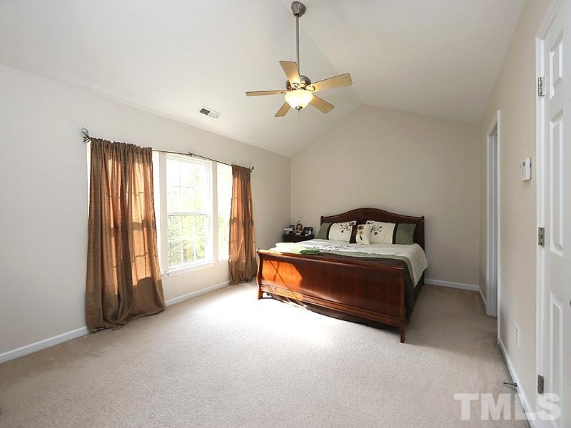 2304 Spruce Shadows Lane Raleigh, NC 27614 - Photo 10 of 25 a spacious bedroom with a bed and a window