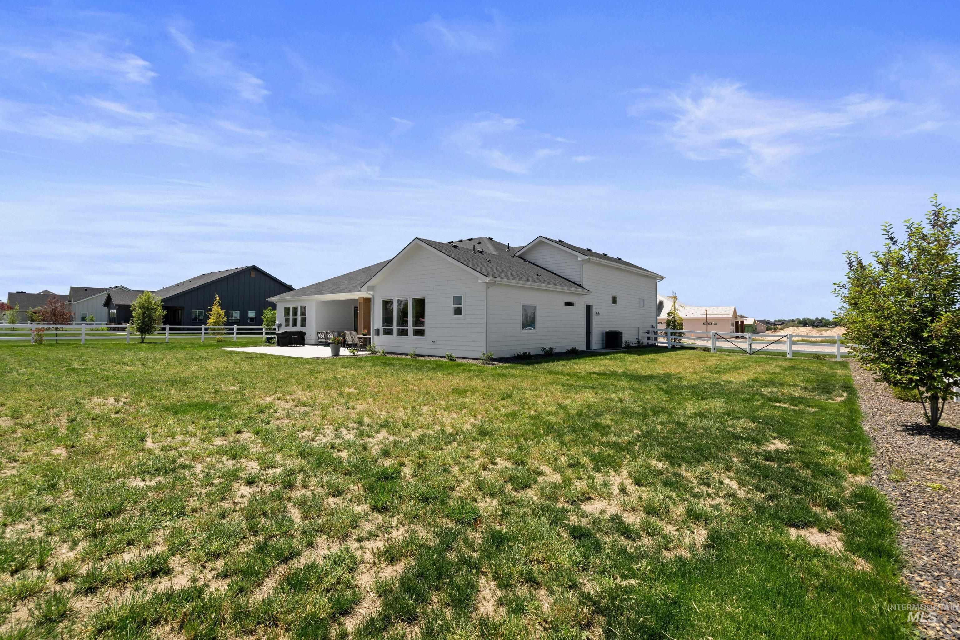 24990 Belgian Way Middleton, ID 83644 - Photo 43 of 50 Rear exterior featuring white siding and a covered patio with a concrete surface