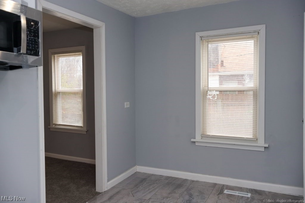 4655 Osborn Road Cleveland, OH 44128 - Photo 16 of 25 Carpeted empty room with a healthy amount of sunlight