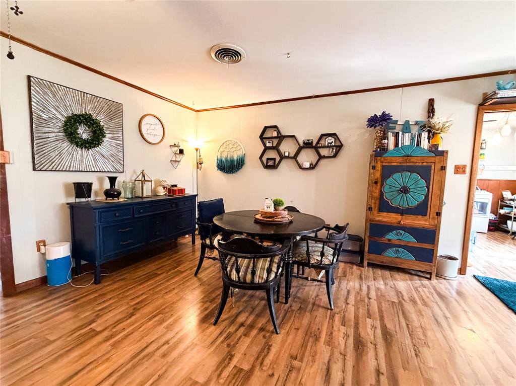 1706 North Ave H Haskell, TX 79521 - Photo 10 of 25 a view of a dining room with furniture and wooden floor
