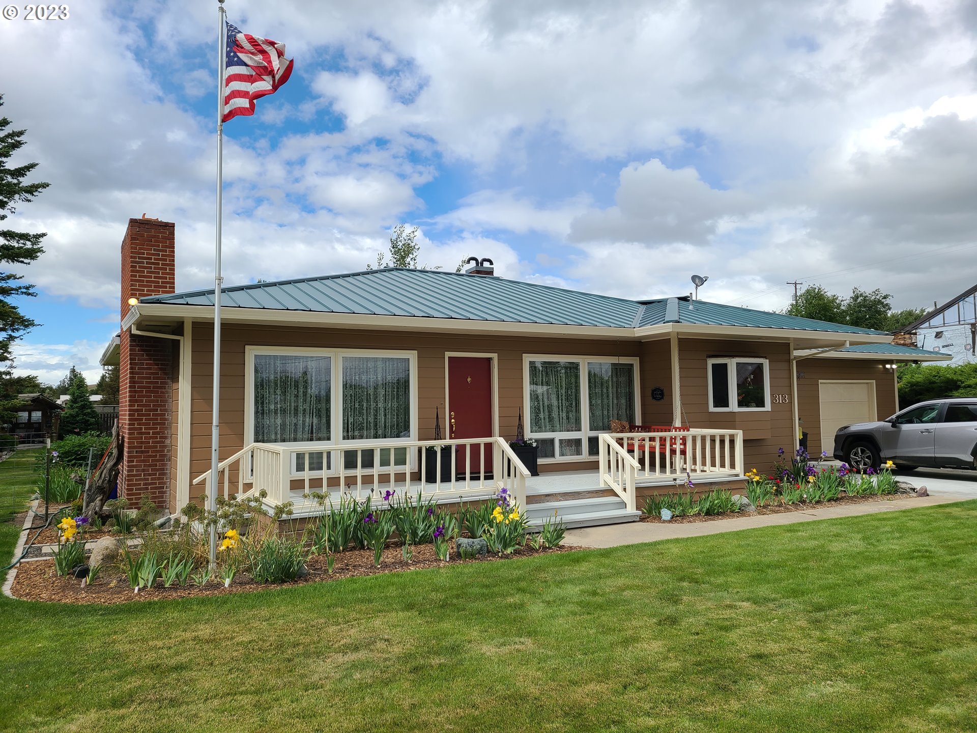 313 Northeast Garfield Street Enterprise, OR 97828 - Photo 1 of 24 a front view of a house with a garden