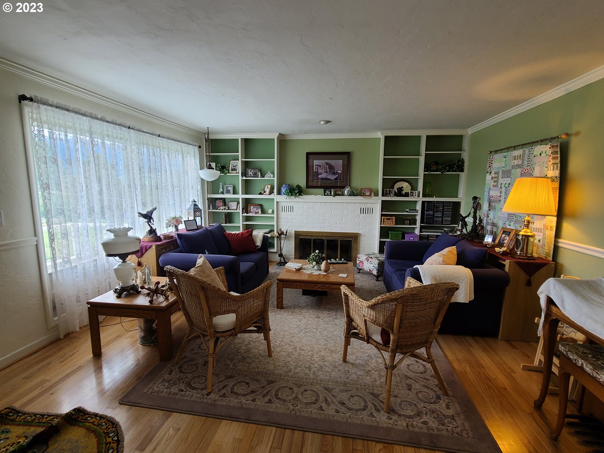 313 Northeast Garfield Street Enterprise, OR 97828 - Photo 11 of 24 a living room with furniture and a fireplace