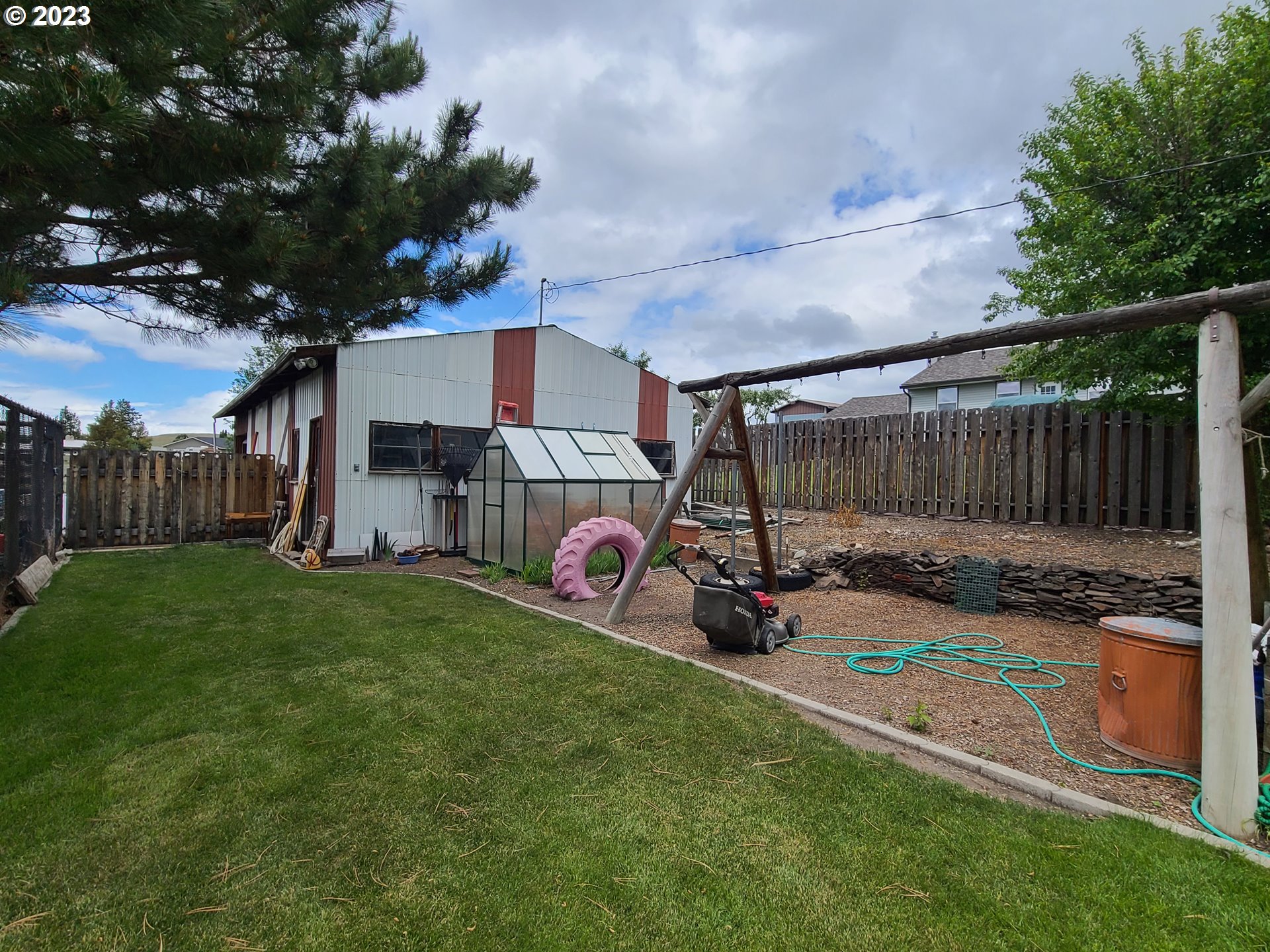 313 Northeast Garfield Street Enterprise, OR 97828 - Photo 13 of 24 a view of a backyard with wooden fence and a bench