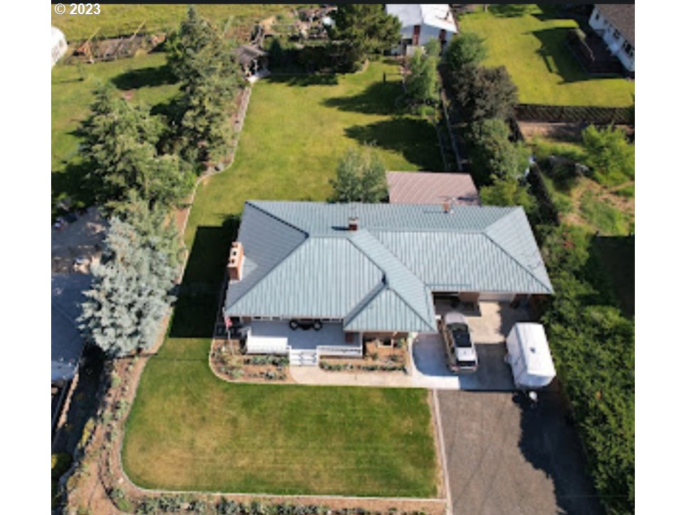 313 Northeast Garfield Street Enterprise, OR 97828 - Photo 16 of 24 an aerial view of a house with swimming pool and lake view