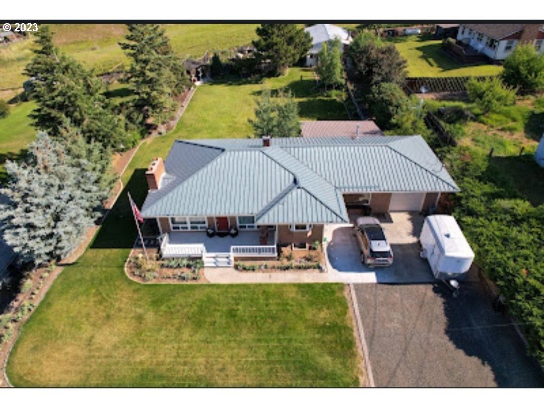 313 Northeast Garfield Street Enterprise, OR 97828 - Photo 17 of 24 a aerial view of a house with swimming pool and porch