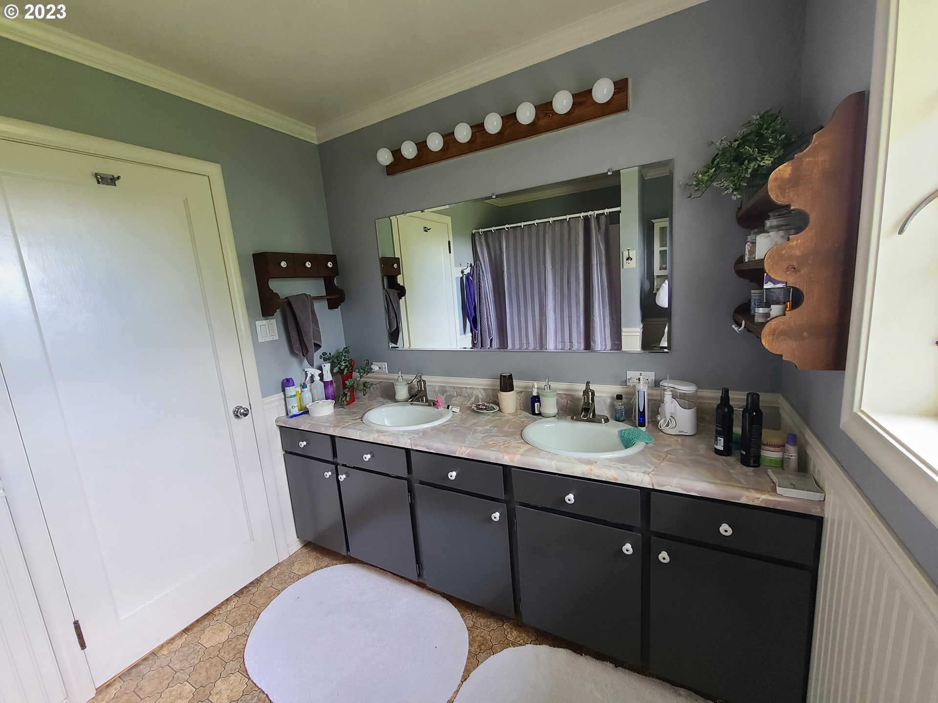 313 Northeast Garfield Street Enterprise, OR 97828 - Photo 2 of 24 a bathroom with a granite countertop sink mirror vanity and toilet